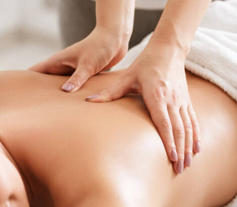 Body care. Young girl having massage, relaxing in spa salon, closeup